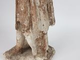 an old statue of a man with a hat and a cane