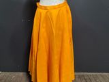 a mannequin wearing a white top and yellow skirt