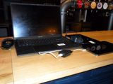 a laptop computer sitting on top of a wooden desk