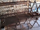 a table and two chairs in a room with a stone wall