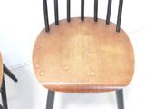 two wooden chairs sitting next to each other on the floor
