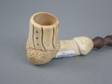a pipe that is sitting on a table next to a piece of wood