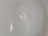 a glass plate with a silver rim on a table