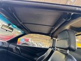 the interior of a car with black leather seats and a sunroof