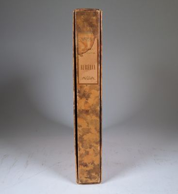 an old book sitting on top of a white table next to a gray wall