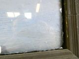 a teddy bear that is sitting in a window sill