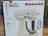 boxed kitchen aid stand mixer on table in kitchen area of home