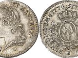 a silver coin with an image of a man in a crown on it