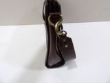 brown leather handbag with a tag hanging from it ' s side