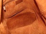 the inside of a brown bag with a zipper on it