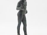 statue of a man holding a ball in his right hand