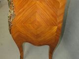 an antique chest of drawers with a marble top in a room