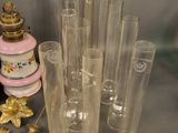 a lot of glass vases and a lamp on the table