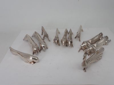 seven pieces of silverware sitting on a white surface