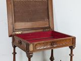 a small wooden box on a stand with a red velvet lining