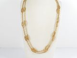 a close up of a mannequin with a gold chain necklace