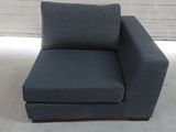 a blue chair with a pillow on it in a room