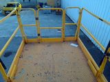 a yellow platform with a yellow gate and a black handle