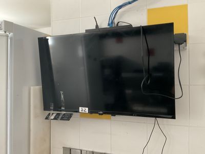 a flat screen tv mounted on the wall in the kitchen