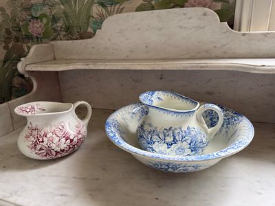 two cups and a bowl sitting on a counter