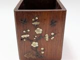 a wooden box with a flower design on it
