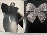 an open book with a picture of a woman in a dress and a bow