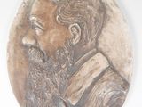 a plaque of a man with a beard on a wall