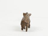 a small figurine of a dog standing in the snow