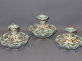 three pieces of blue and white porcelain with flowers on them