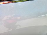 a reflection of a person riding a motorcycle on the side of the road