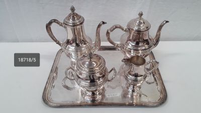 silver plated tea and coffee set on tray on white surface