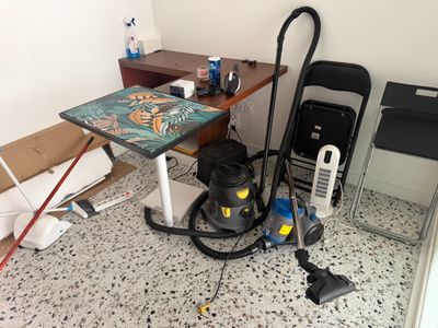 a vacuum that is sitting on the floor next to a table