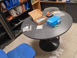 une table avec une chaise bleue et une bibliothèque en arrière-plan