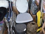 a pile of stuff that includes a chair, a birdcage, a bird cage, and a stuffed animal