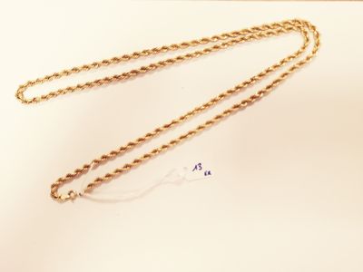 gold plated necklace with a chain on a white surface