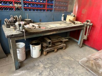 a workbench with a bunch of tools on top of it