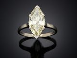 a yellow and white diamond ring on a black surface