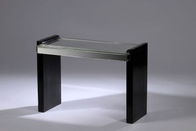 an image of a glass table with a black base and a clear glass top
