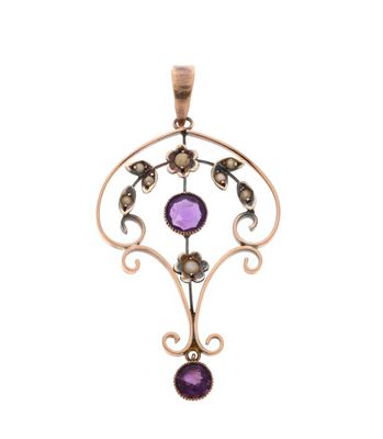 a close up of a pendant with a purple stone on it