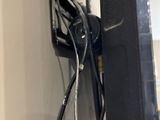 a black television with wires attached to the wall