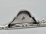 an antique silver plate with a clock on top of it