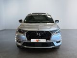 the front view of a silver car in a showroom