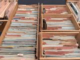 an open wooden box filled with lots of different colored records