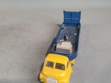 a toy truck that is sitting next to a toy truck
