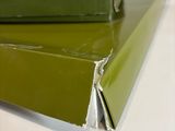 two green boxes sitting on top of each other on a table