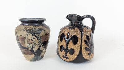 two vases sitting next to each other on a white surface