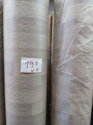 several rolls of fabric are stacked on top of each other in a warehouse
