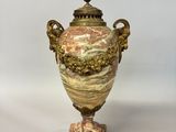 a vase that is sitting on a stand on a table