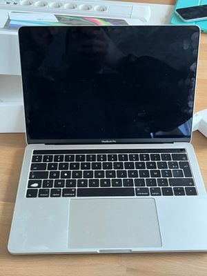 a laptop computer sitting on top of a wooden table