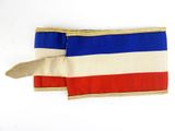 a red, white, and blue flag on a white surface